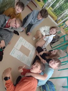 uczniowie na podłodze rozkładają karty pracy …<p class=